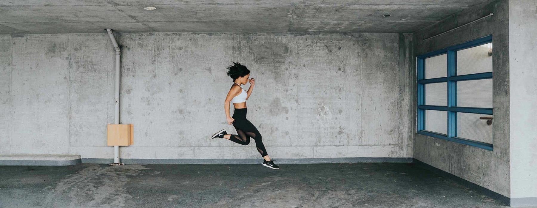 exercising woman caught jumping in mid-air