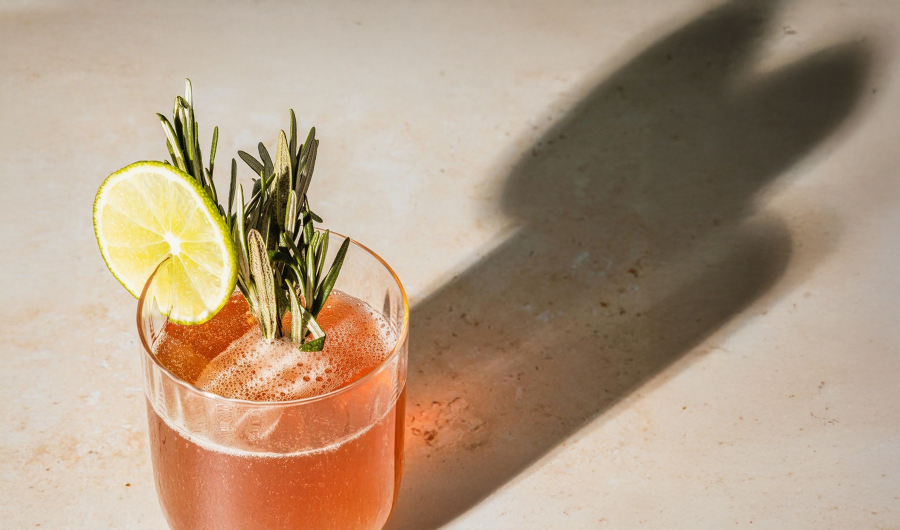 a glass with a drink and a lemon on top