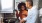 a man and a woman cooking on a gas stove top
