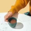 a woman holding a mug of coffee